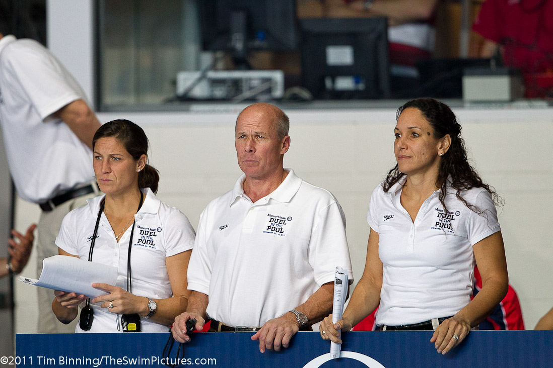 US Coaches Lea Maurer, Jack Bauerle and Kim Brackin
 look on during the men's 800m Freestyle at the 2011 Mutual of Omaha Duel in the Pool held December 16 and 17, 2011 at Georgia Tech University in Atlanta, Georgia.