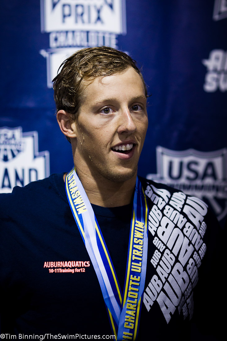 Tyler McGill of Auburn Aquatics on the medal stand following his victory in the 100 butterfly