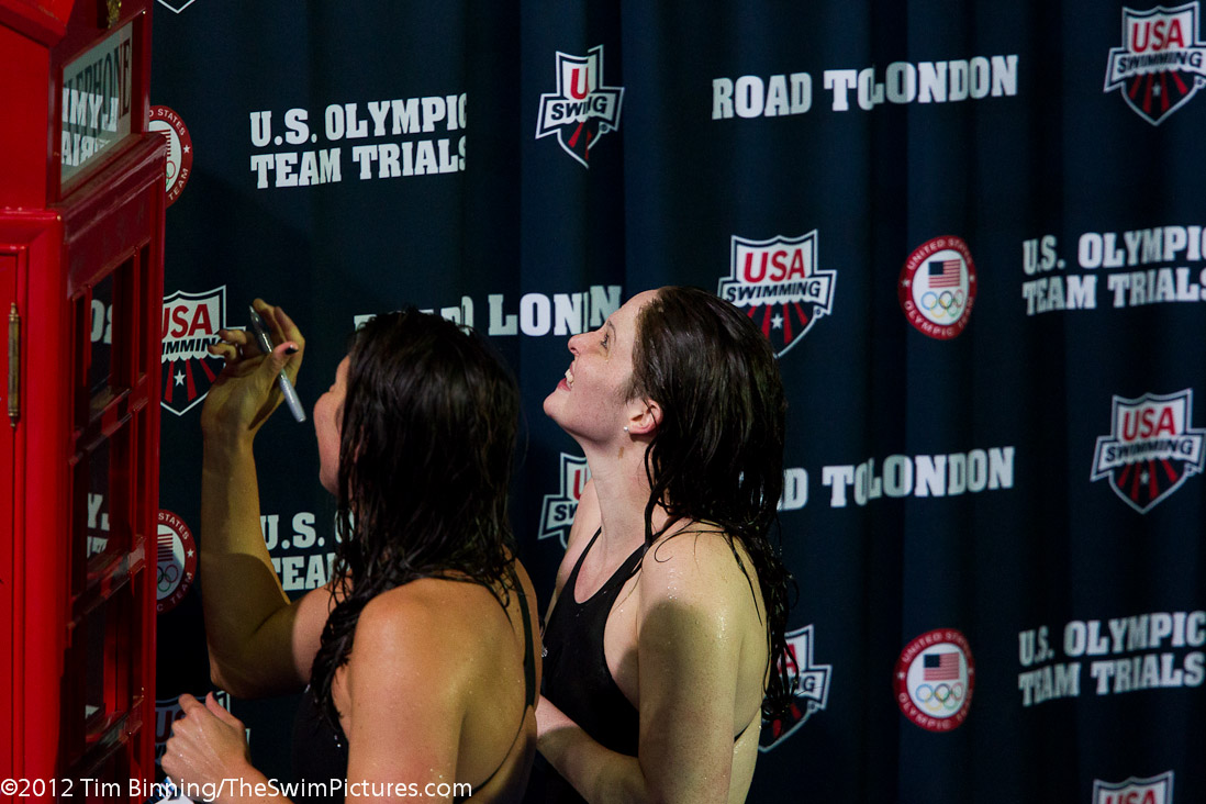 Kathleen Hersey (L) and Camille Adams (R) sign the phone booth after qualifying for the US Olympic Team in the 200 fly. | 20, 22, Adams, Aggie Swim Club, Cammille Adams, GU, Hersey, Kathleen Hersey, Longhorn Aquatic, ST, _Adams_Cammille, _Hersey_Kathleen