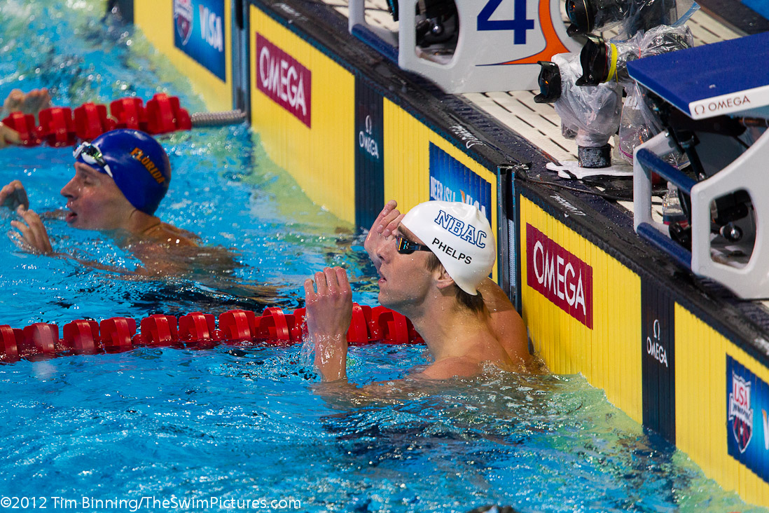 Michael Phelps and Ryan Lochte check the clock after a close finish in the 200 IM final.
